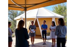Outdoor corporate retreat meeting area with glamping tents in the background